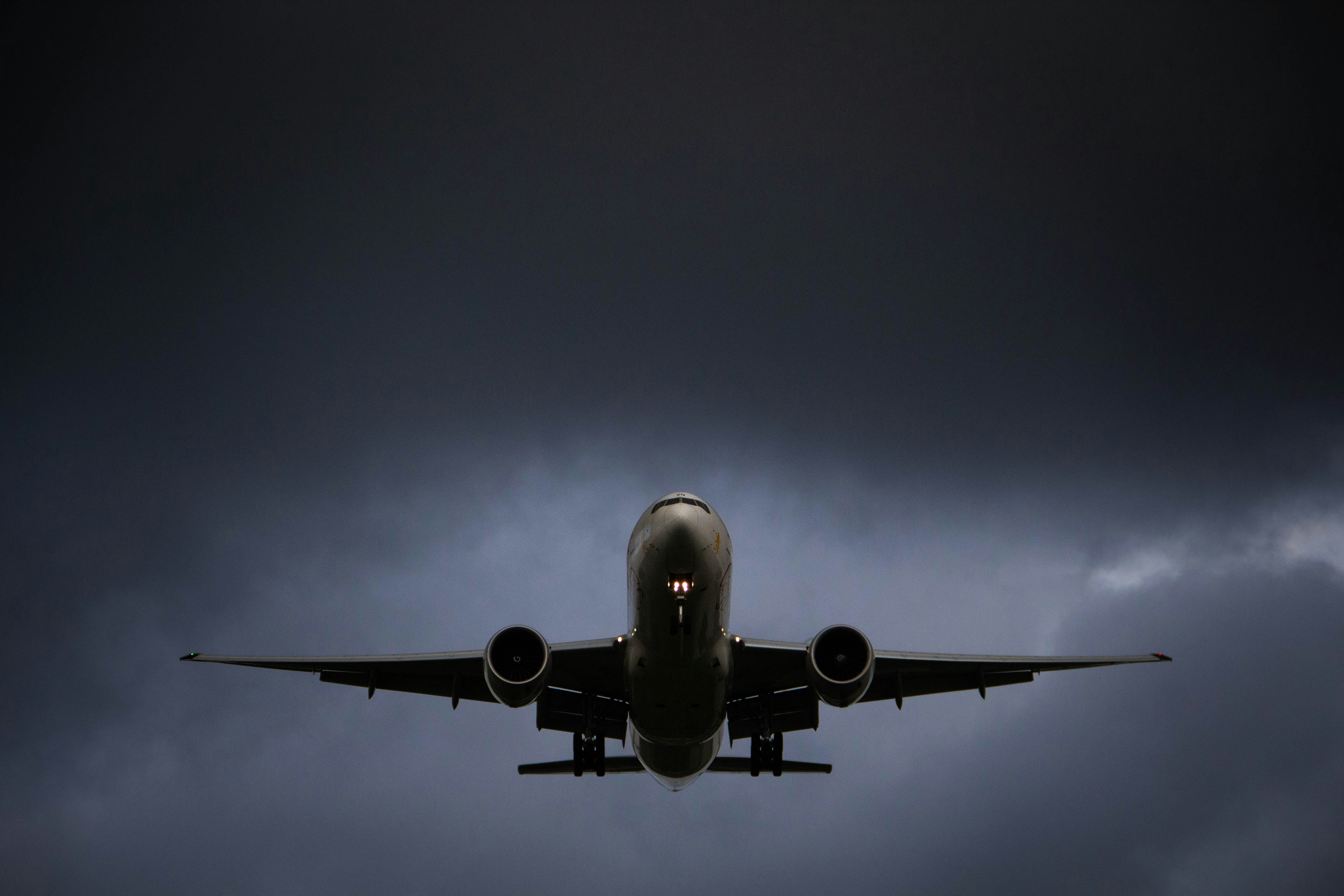 A large jetliner flying through a cloudy sky